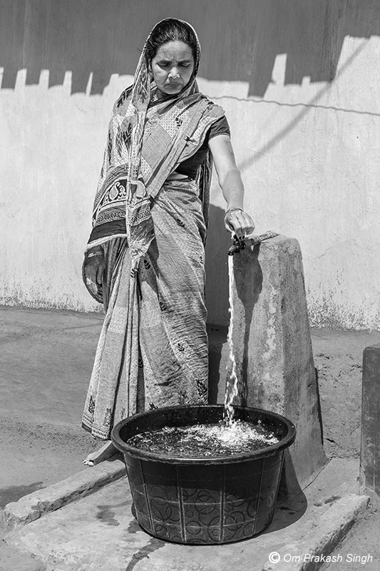 Collecting water from a JJM functional household tap connection (FHTC) located just outside the domestic premises in Seraikela-Kharsawan district, Jharkhand, India
